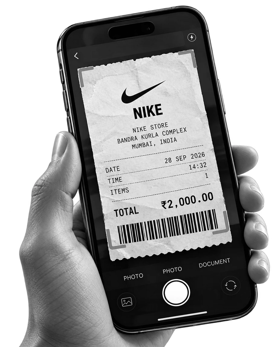 A hand holding a phone that is scanning a Nike receipt for ₹2,000 dated 28 Sep 2026